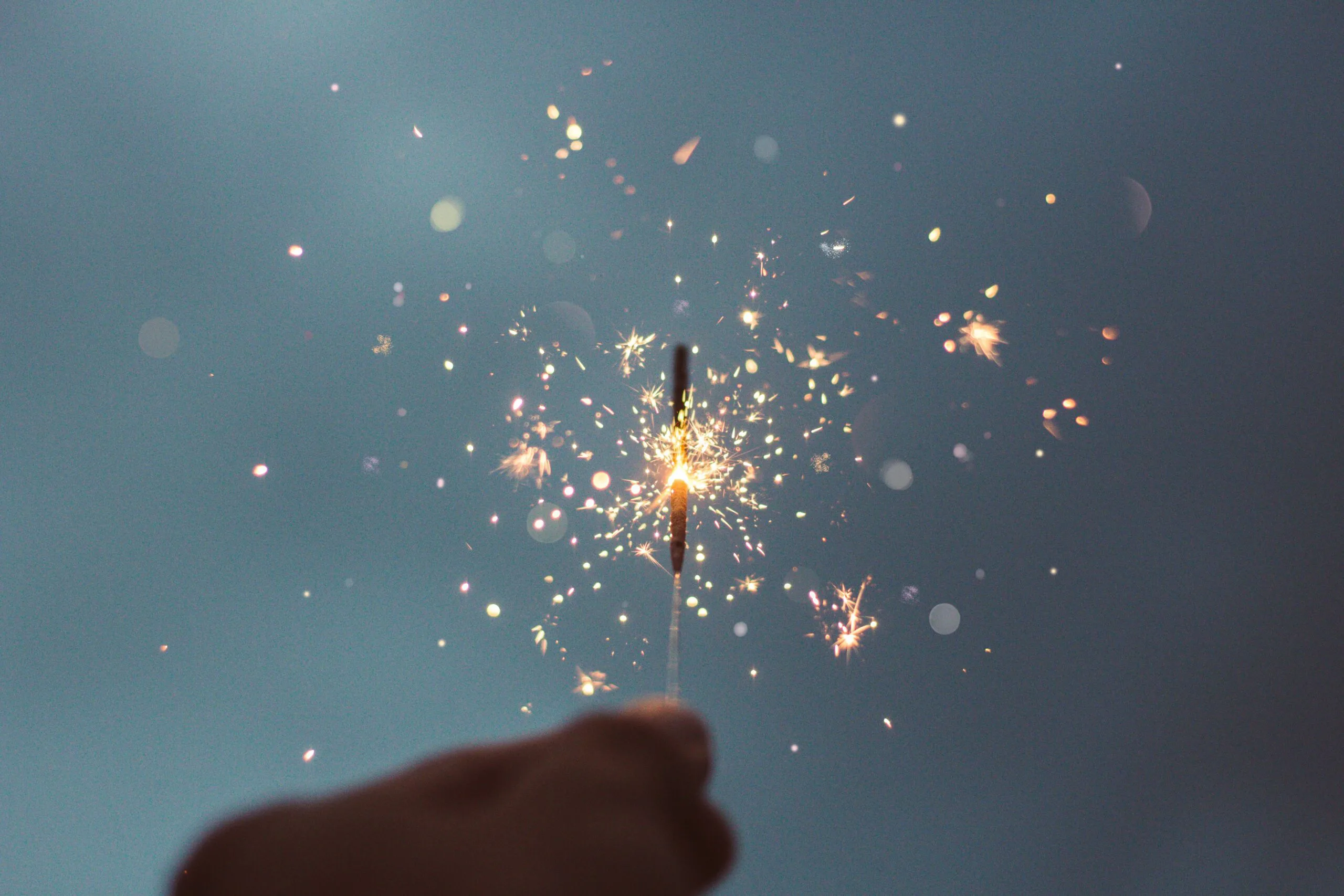 Picture of a hand holding a firework sparkler