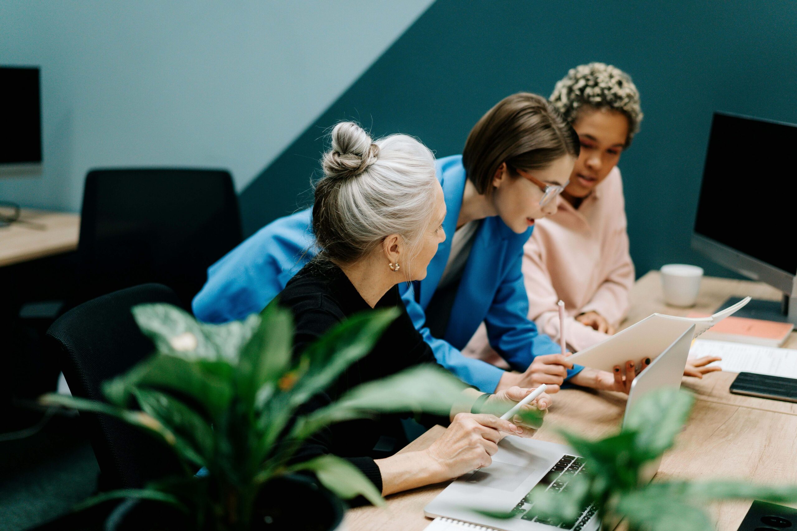 An image of three women reviewing a business report.
