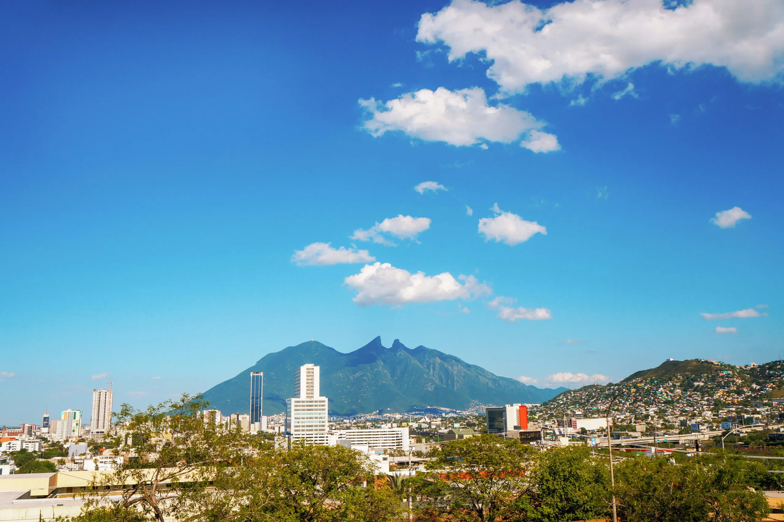 Photo of a city with a mountain in the background