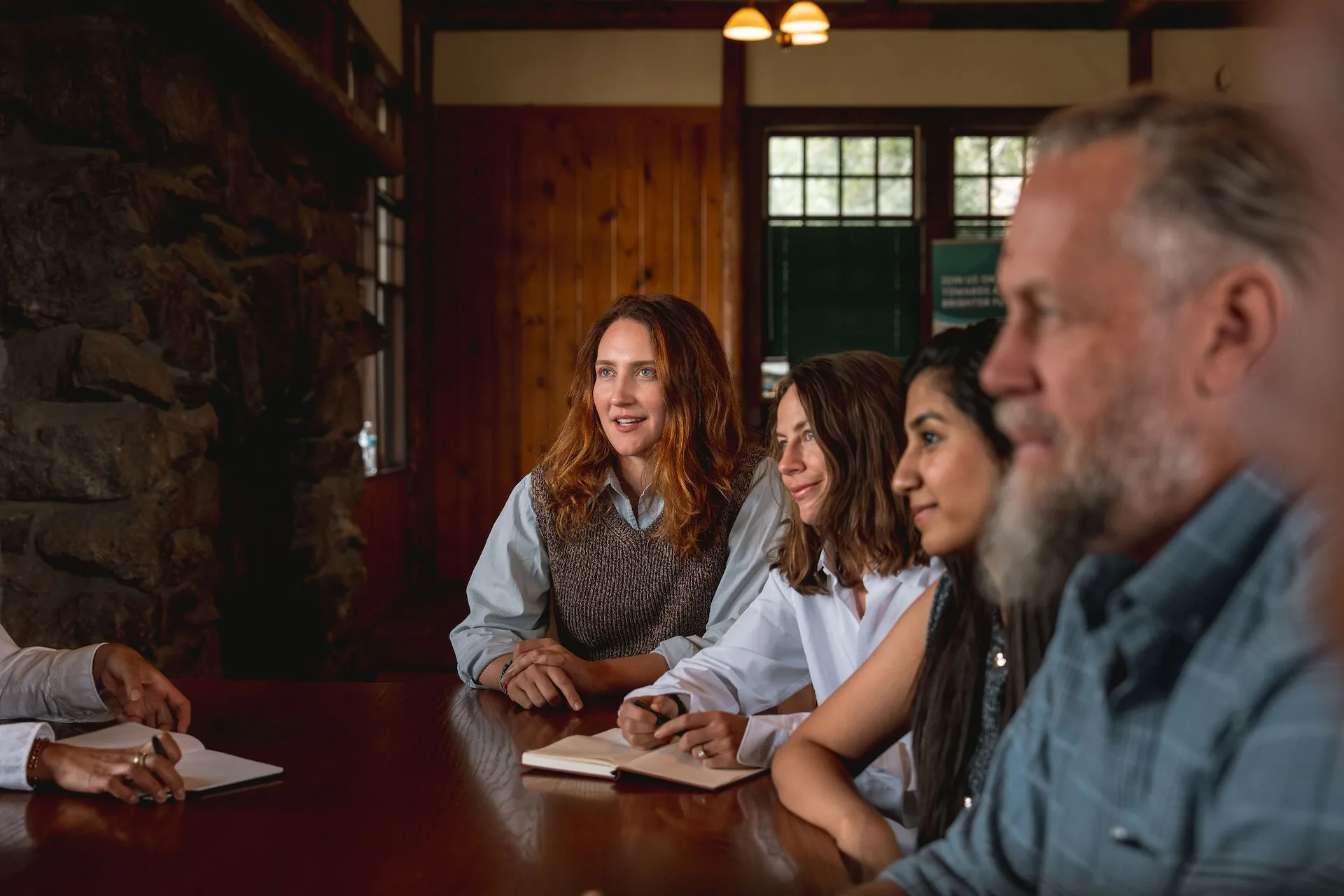 Group of people sitting around a table in a meeting